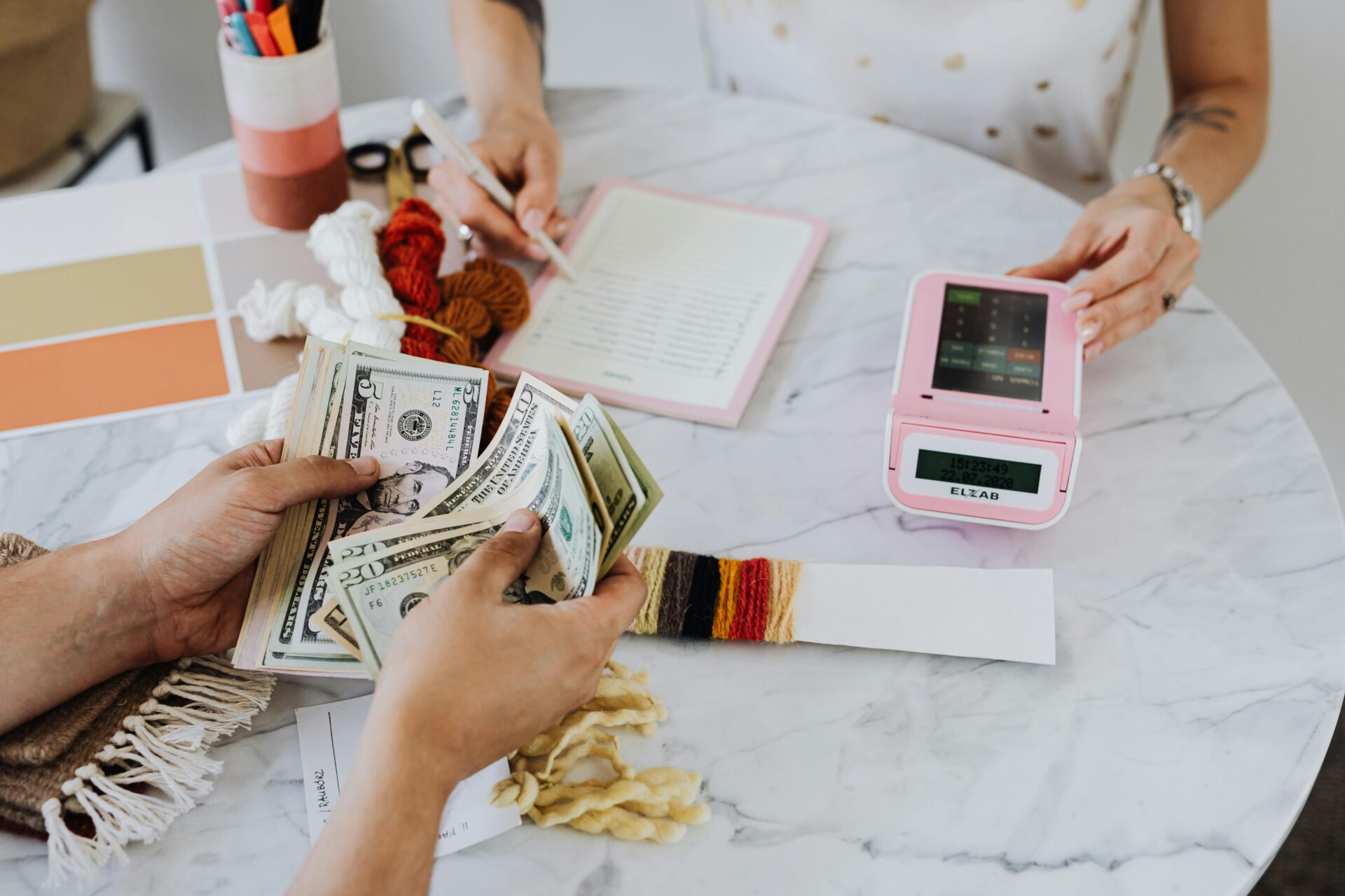 A small business owner counting cash after receiving a small business loan without collateral.