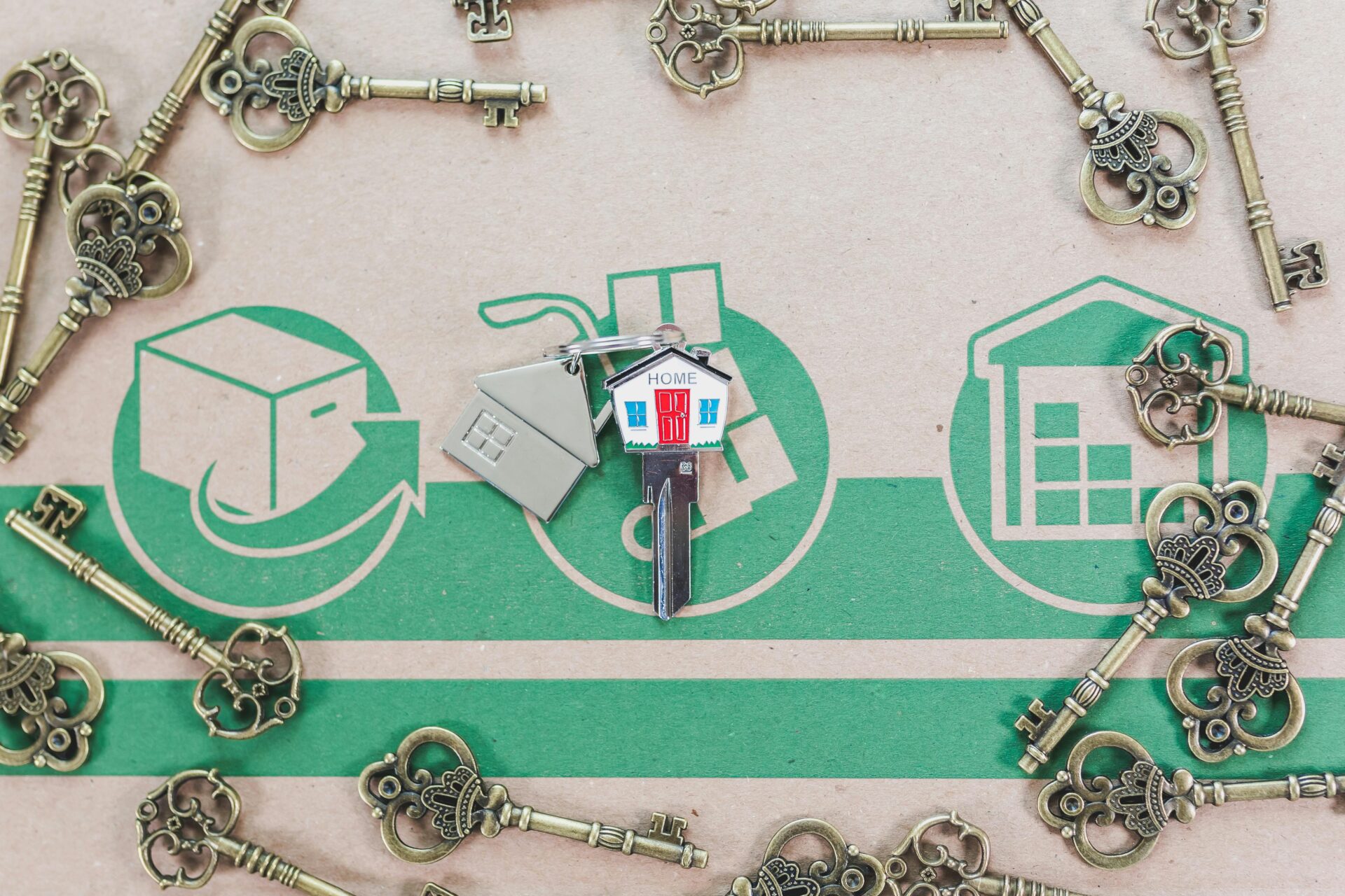 A house keychain surrounded by ornate keys on a real estate backdrop, representing real estate investing opportunities.